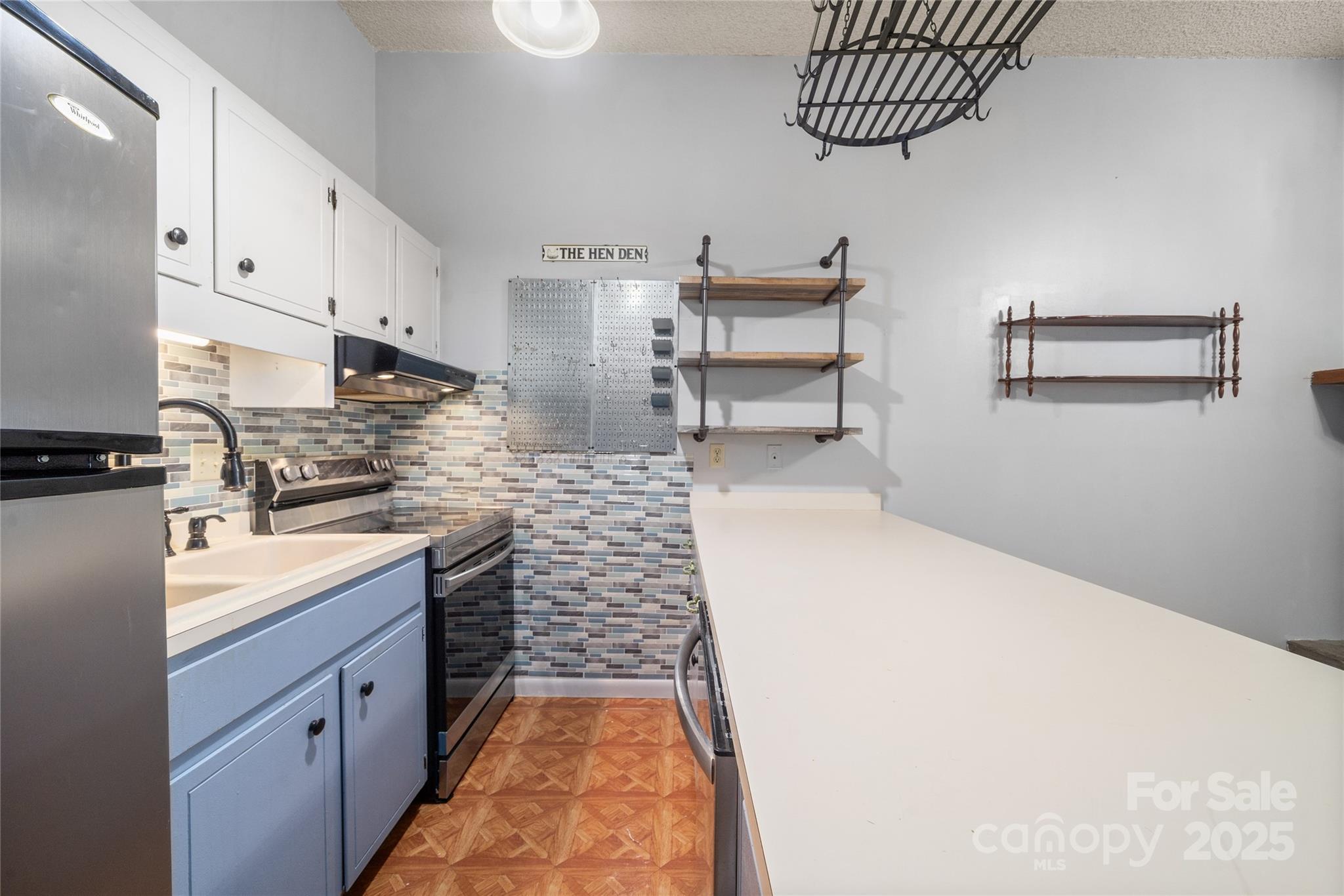 94 Market Street Maggie Valley, NC 28751 - Photo 17 of 40 a kitchen with sink cabinets and window