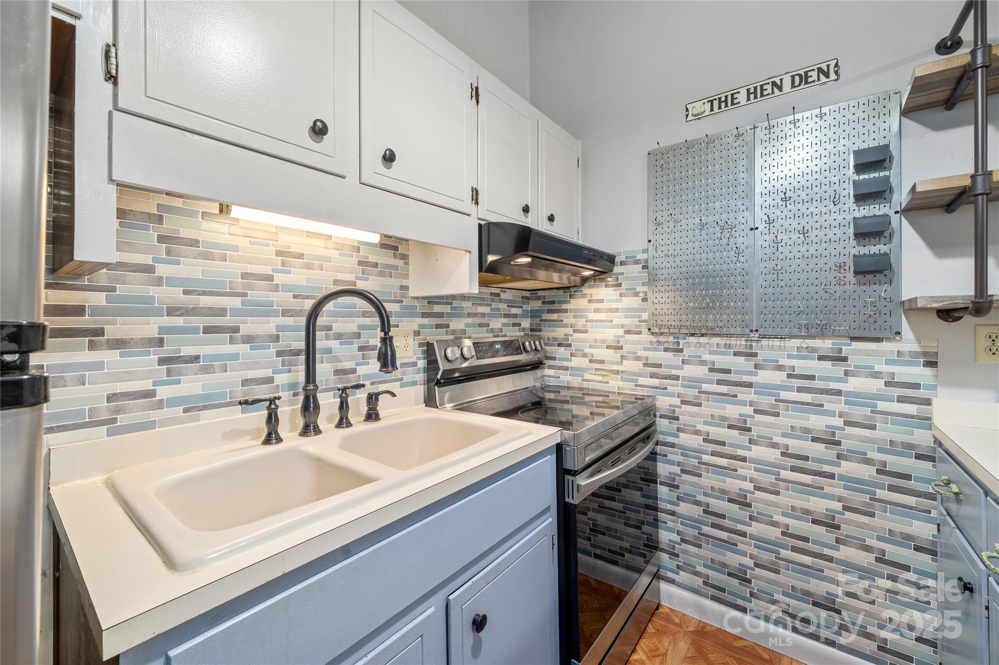 94 Market Street Maggie Valley, NC 28751 - Photo 18 of 40 a kitchen with a sink and cabinets