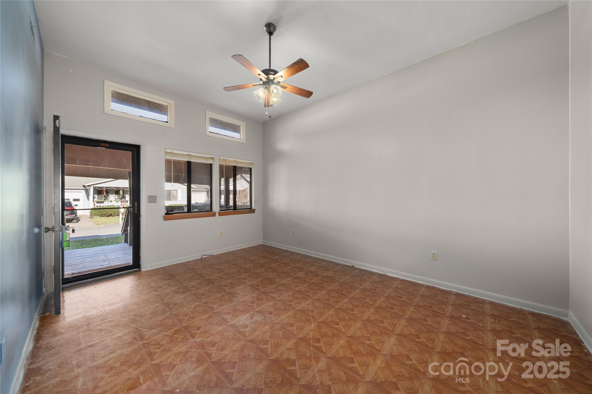 94 Market Street Maggie Valley, NC 28751 - Photo 2 of 40 an empty room with windows and ceiling fan