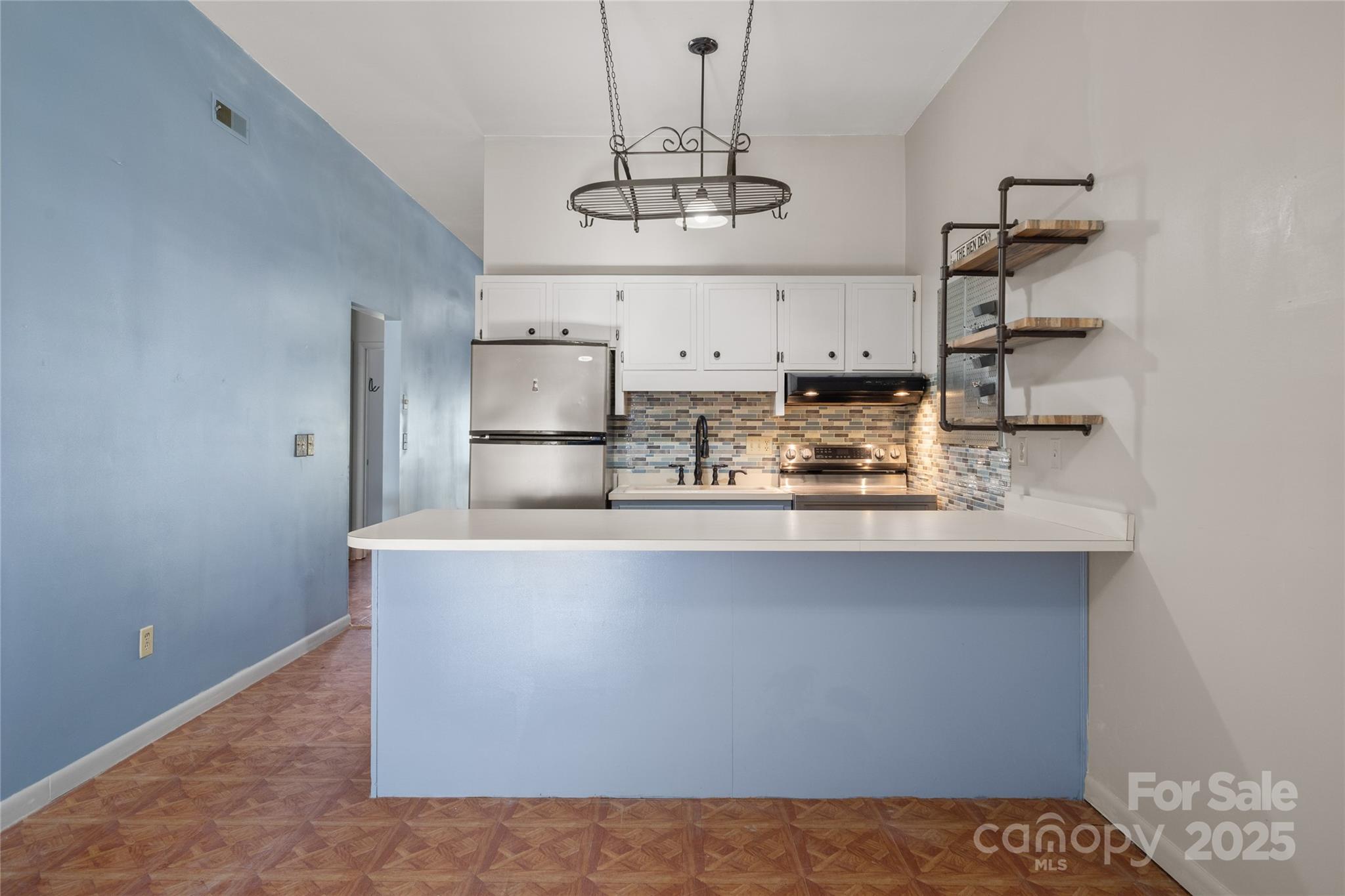 94 Market Street Maggie Valley, NC 28751 - Photo 21 of 40 a view of kitchen with stainless steel appliances granite countertop a sink and cabinets