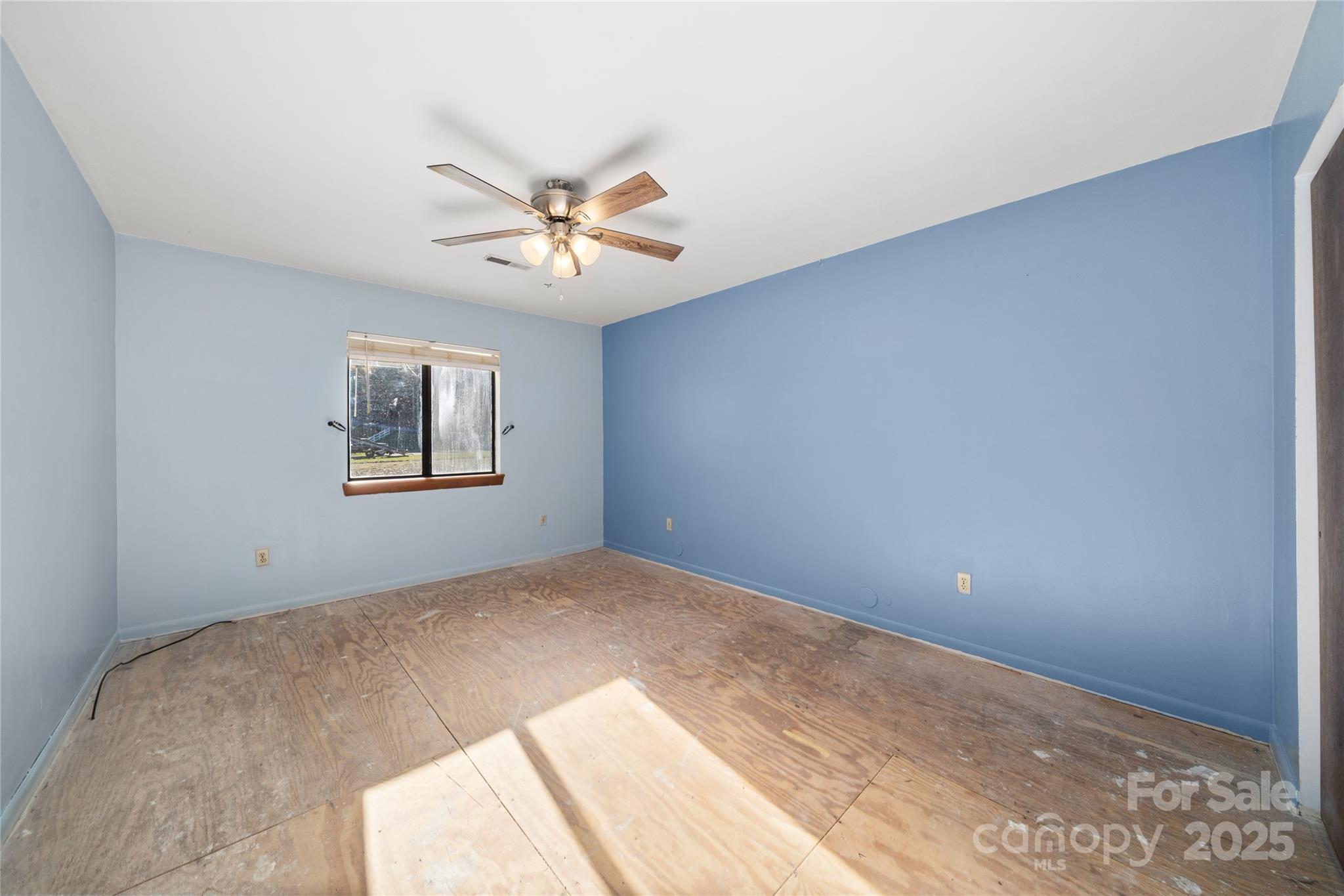 94 Market Street Maggie Valley, NC 28751 - Photo 27 of 40 a bedroom with a fan and a window