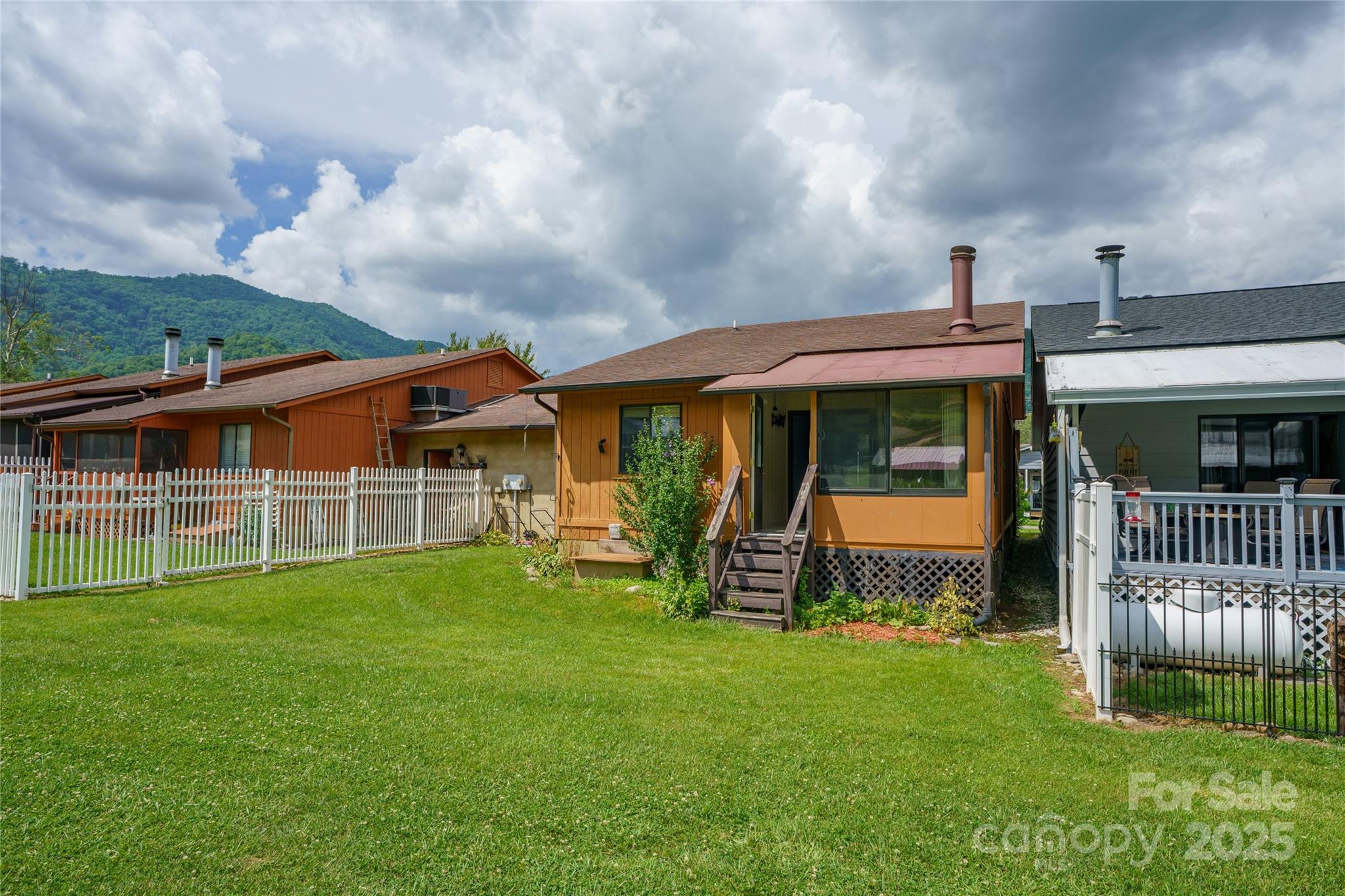 94 Market Street Maggie Valley, NC 28751 - Photo 38 of 40 a front view of a house with garden