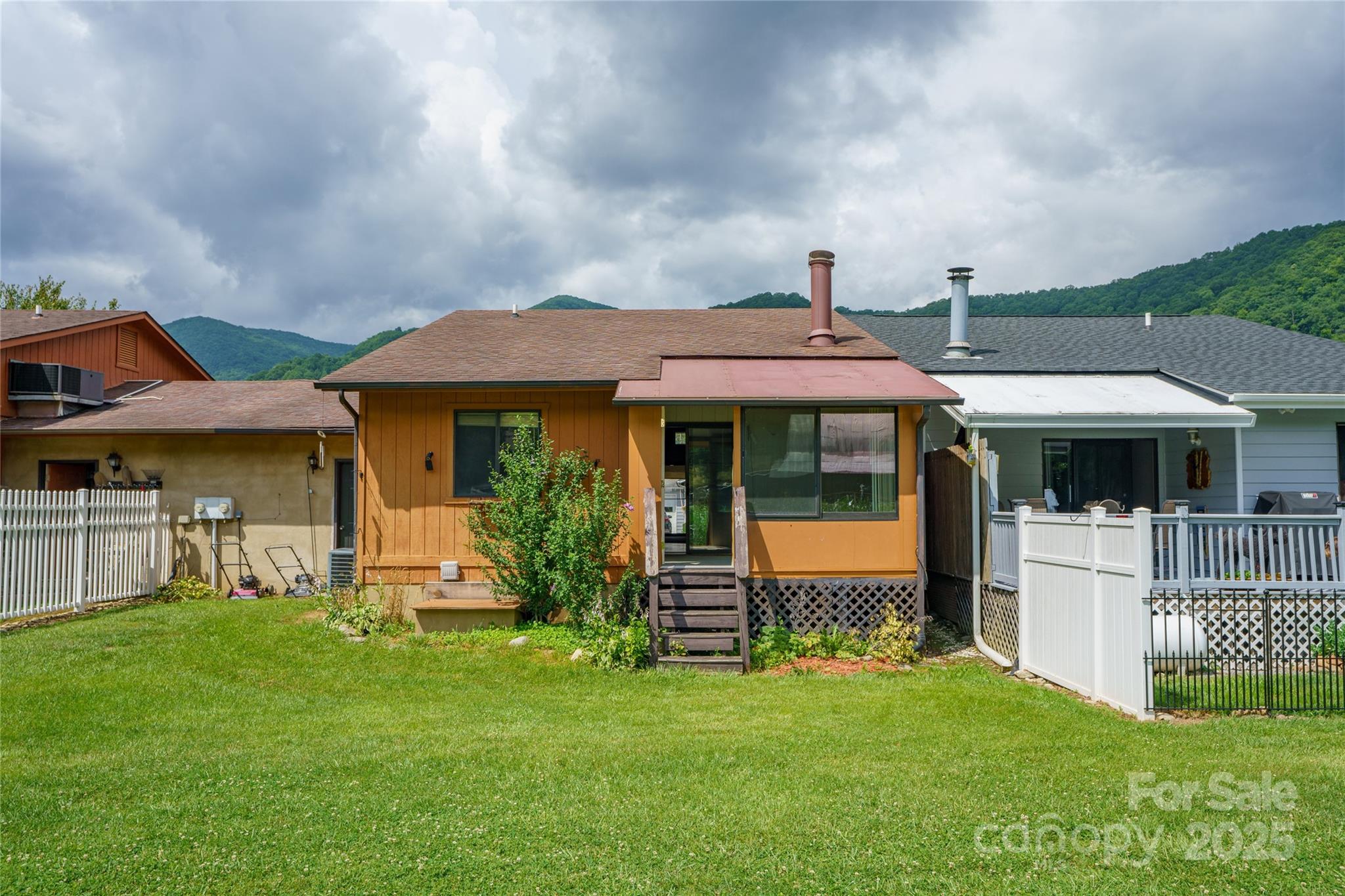 94 Market Street Maggie Valley, NC 28751 - Photo 39 of 40 a front view of a house with garden