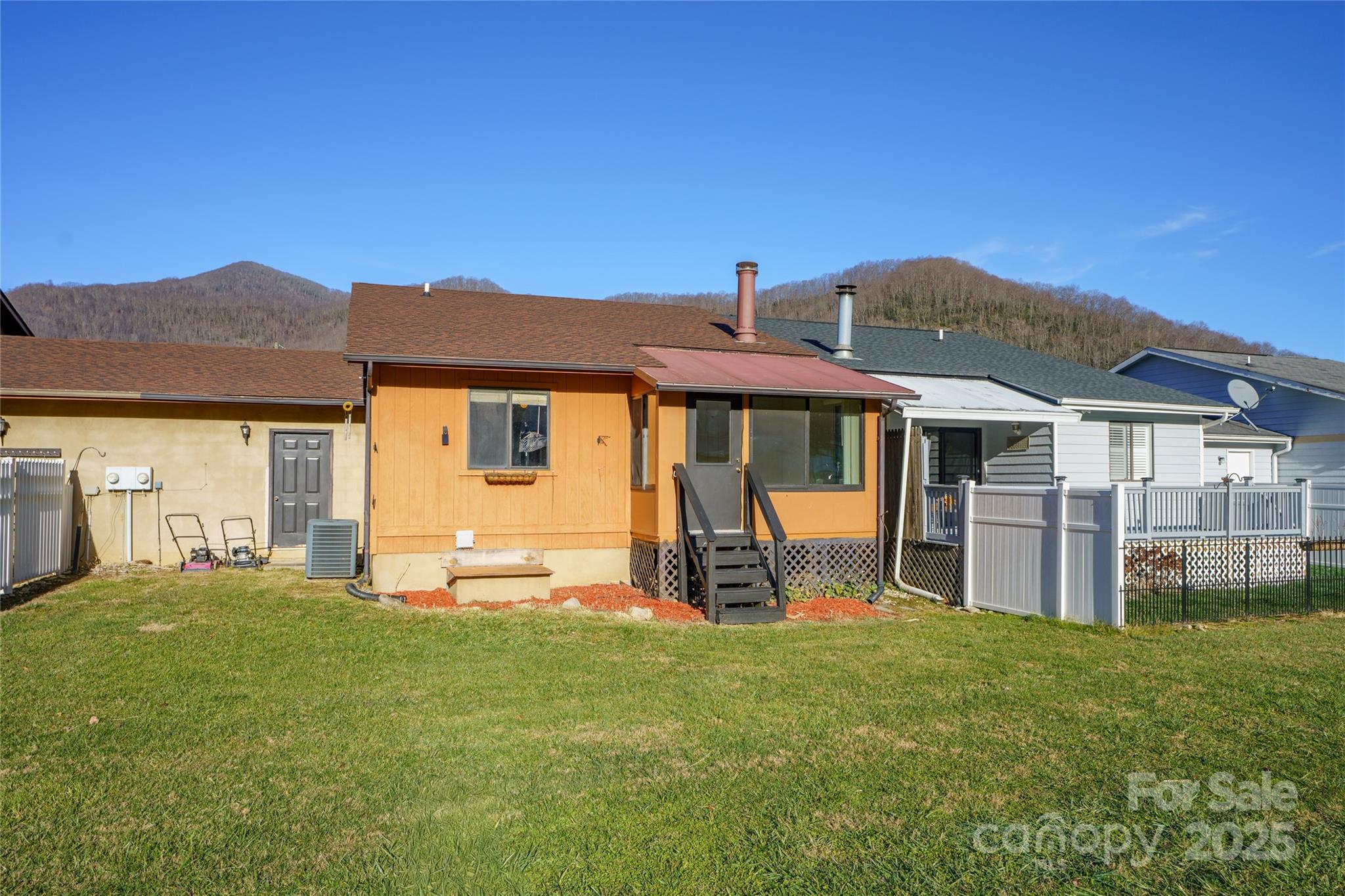 94 Market Street Maggie Valley, NC 28751 - Photo 9 of 40 a front view of a house with a yard