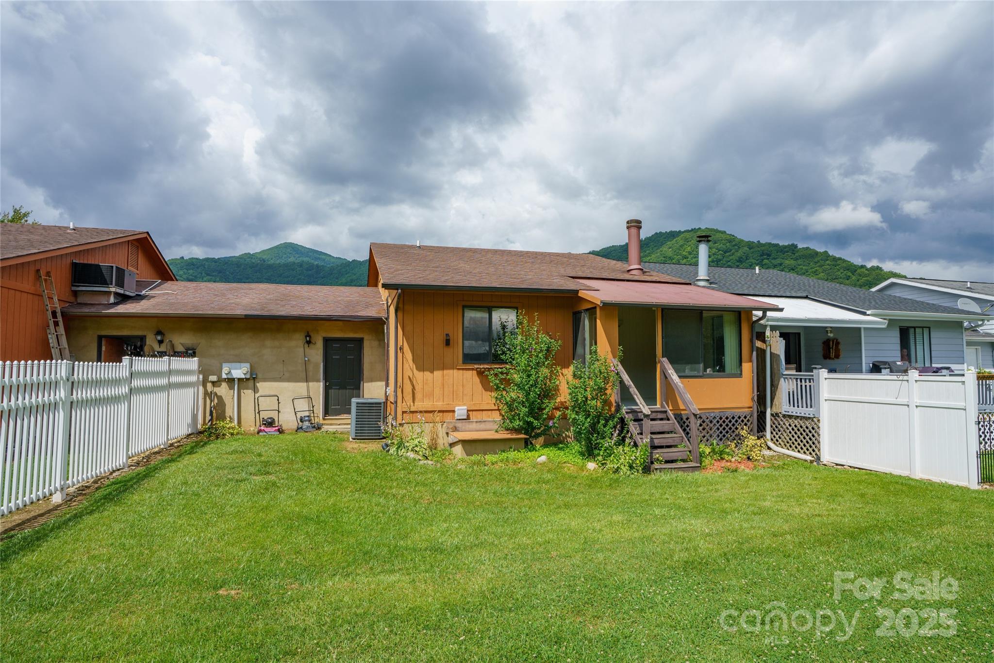 94 Market Street Maggie Valley, NC 28751 - Photo 10 of 40 a front view of house with yard and porch