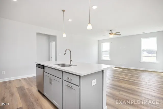 a kitchen with white cabinets and black appliances