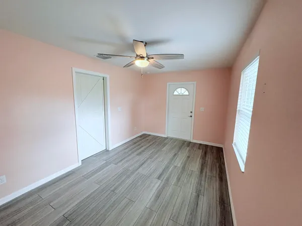 wooden floor in an empty room with a window