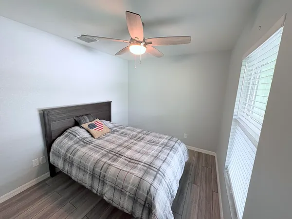 a bedroom with bed and a window
