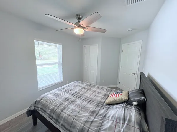 a bedroom with a bed and a window