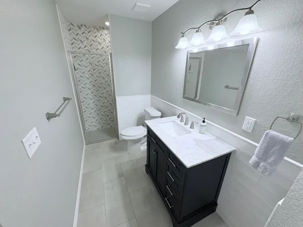 a bathroom with a sink toilet and mirror