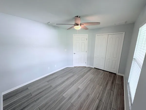 wooden floor in an empty room with a window