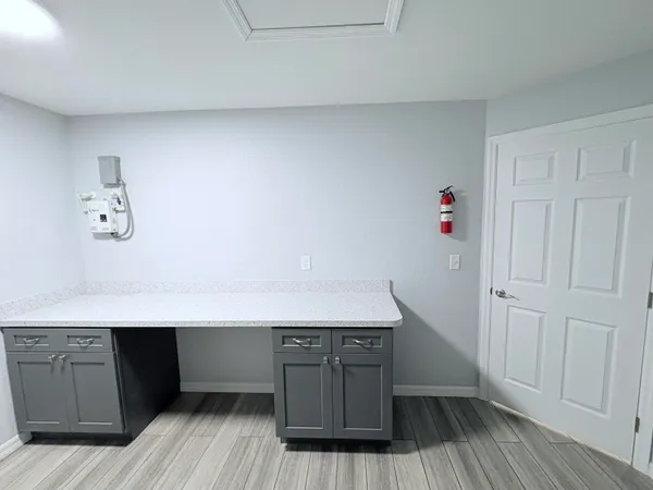 a room with wooden floors and wooden cabinets
