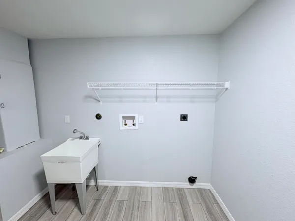 a view of a room with a sink and a mirror