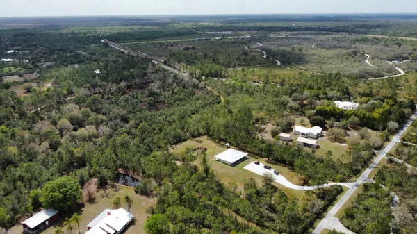 an aerial view of a houses with a yard