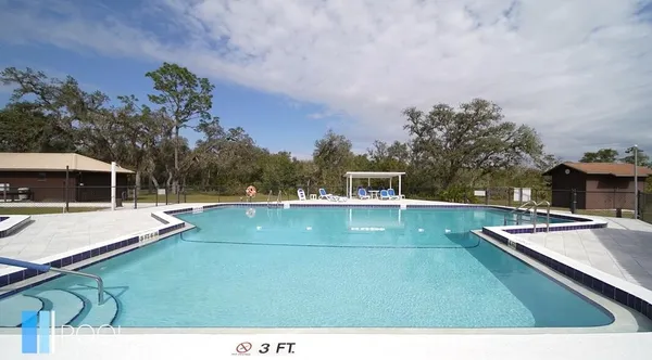 a view of a swimming pool with a yard