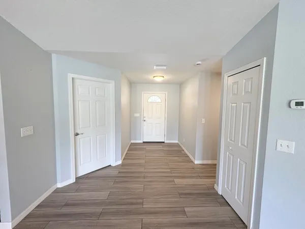 a view of a hallway with wooden floor