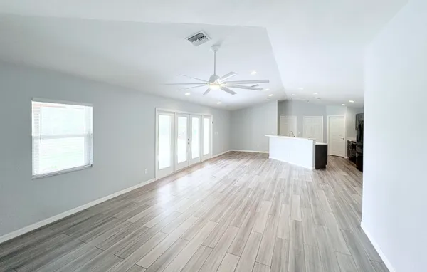 a view of a room with wooden floor and window