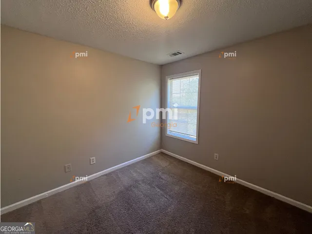 an empty room with a empty space and windows