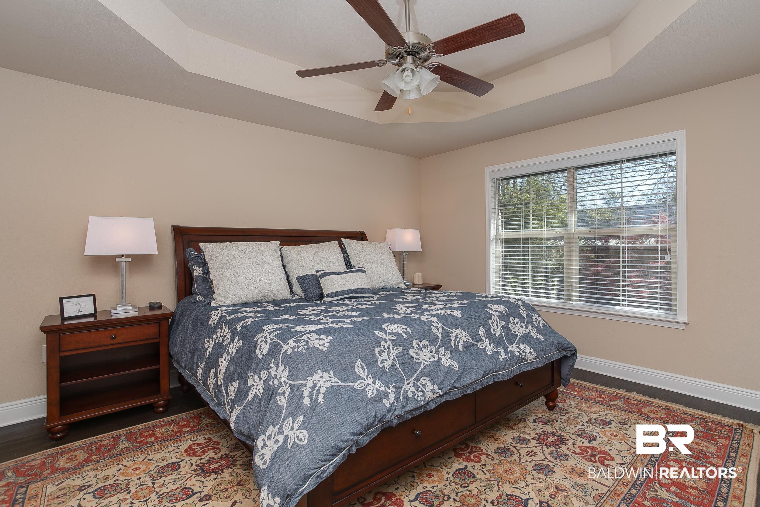 13154 Vincent Court Foley, AL 36535 - Photo 13 of 41 Bedroom with a raised ceiling, baseboards, ceiling fan, and wood finished floors