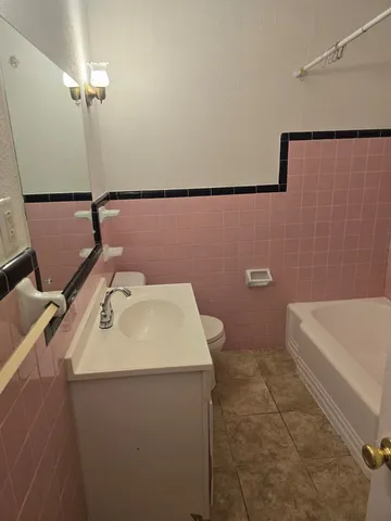 a bathroom with a sink a toilet and mirror