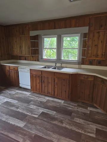 a kitchen with stainless steel appliances granite countertop wooden cabinets a sink and dishwasher
