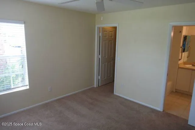 an empty room with windows and closet