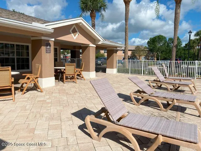 a view of a patio with table and chairs and potted plants