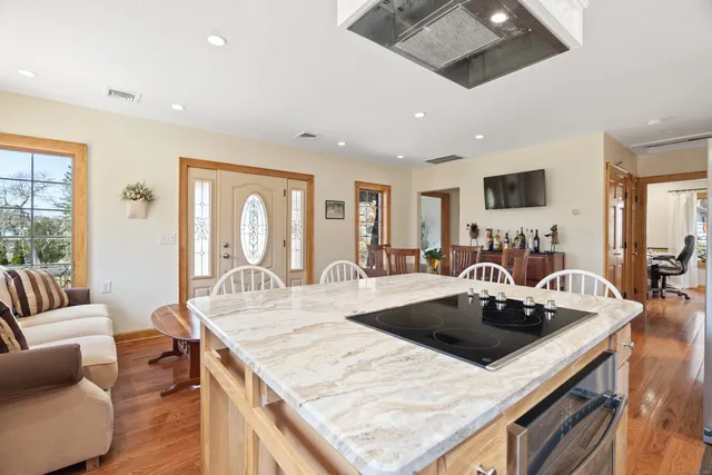 a view of kitchen island a sink and living room