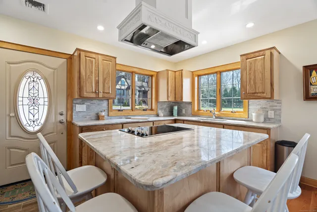 a dining table with chairs and window