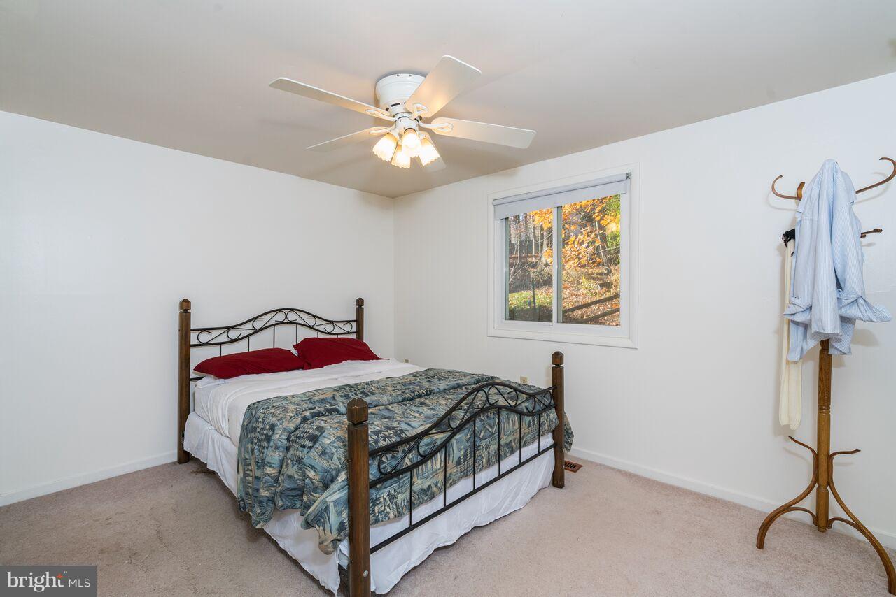 2330 Old Trail Drive Reston, VA 20191 - Photo 12 of 28 a bedroom with a bed and a chandelier