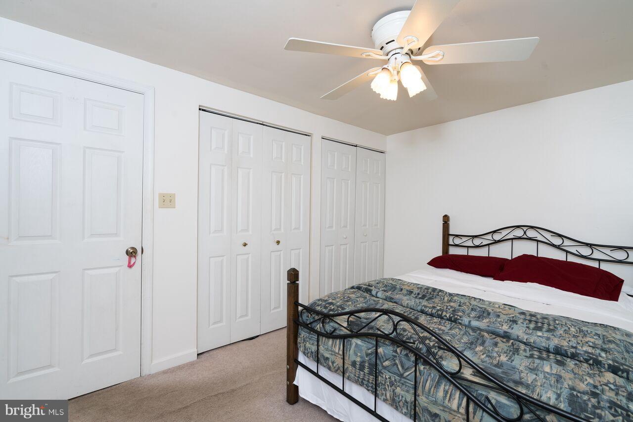 2330 Old Trail Drive Reston, VA 20191 - Photo 13 of 28 a bedroom with a bed and a chandelier