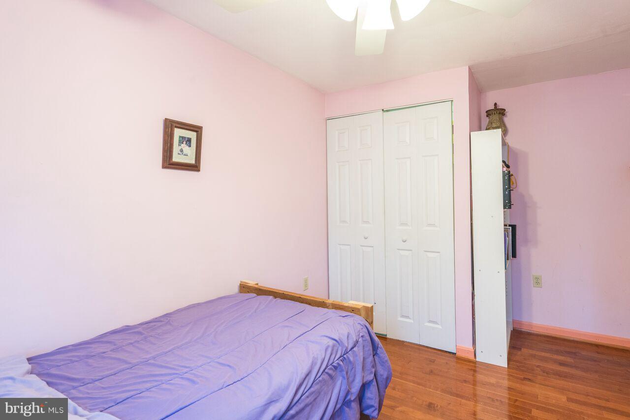 2330 Old Trail Drive Reston, VA 20191 - Photo 15 of 28 a bedroom with a bed and wooden floor