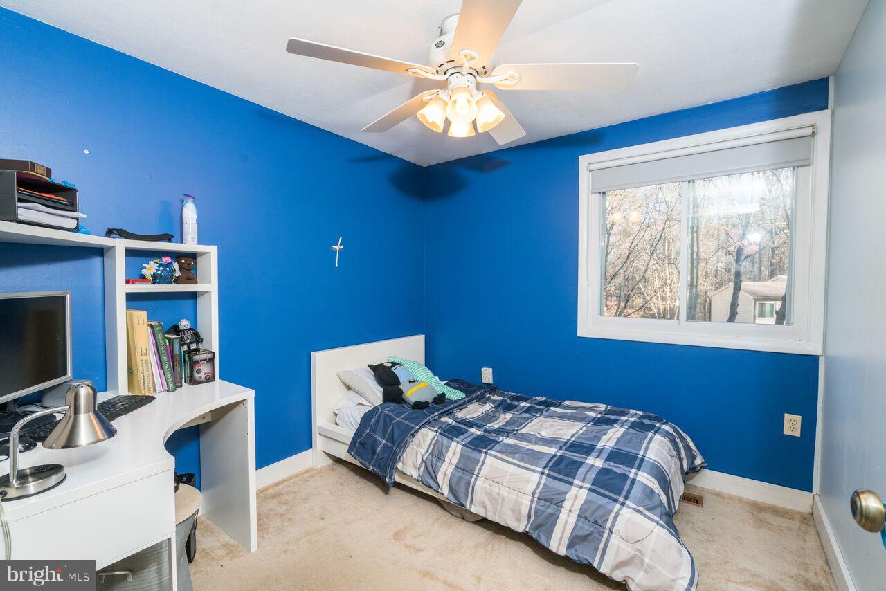 2330 Old Trail Drive Reston, VA 20191 - Photo 16 of 28 a bedroom with a bed and a bookshelf