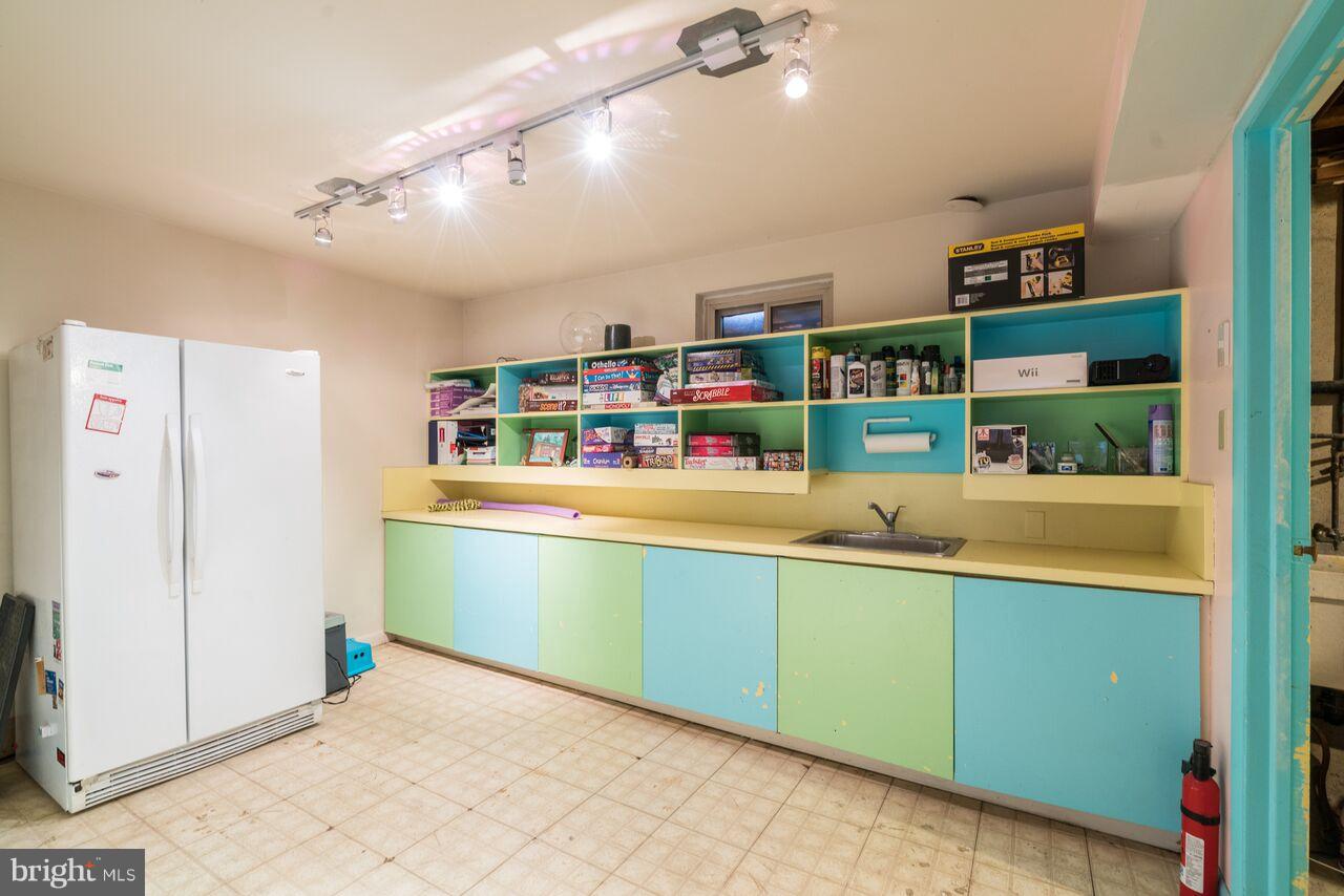 2330 Old Trail Drive Reston, VA 20191 - Photo 25 of 28 a room with lots of white cabinets and blue walls