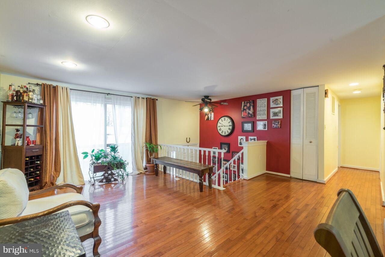 2330 Old Trail Drive Reston, VA 20191 - Photo 6 of 28 a living room with furniture with wooden floor and a large window