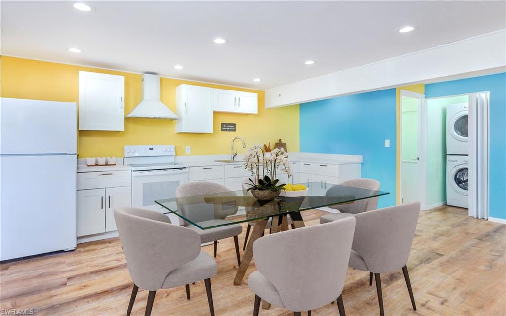 12277 Boat Shell Drive Matlacha Isles, FL 33991 - Photo 36 of 46 a kitchen with a table chairs and a refrigerator