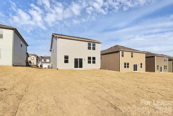a big room with a large bed and large windows