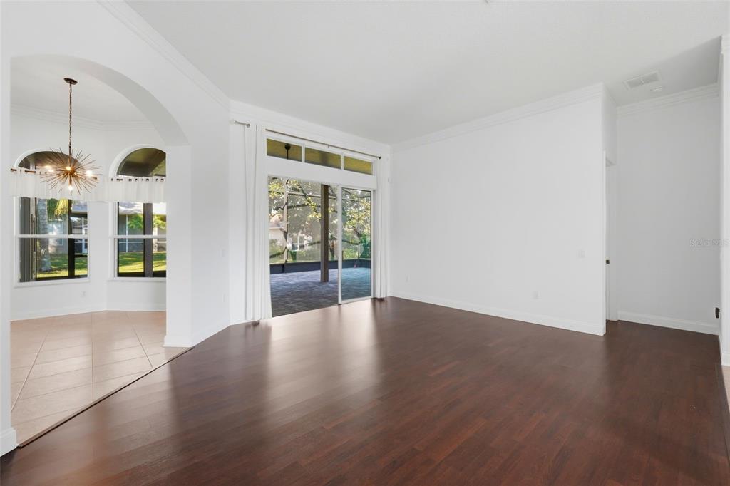 2822 Falcon Ridge Clermont, FL 34711 - Photo 11 of 59 a view of an empty room with wooden floor and windows