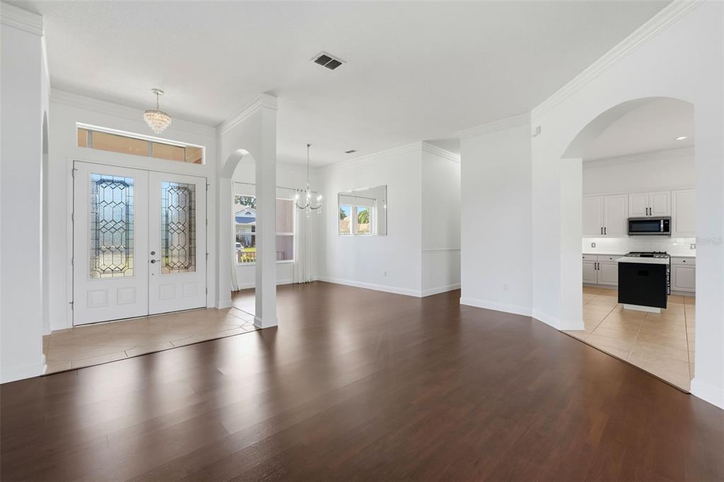 2822 Falcon Ridge Clermont, FL 34711 - Photo 12 of 59 an empty room with wooden floor and windows