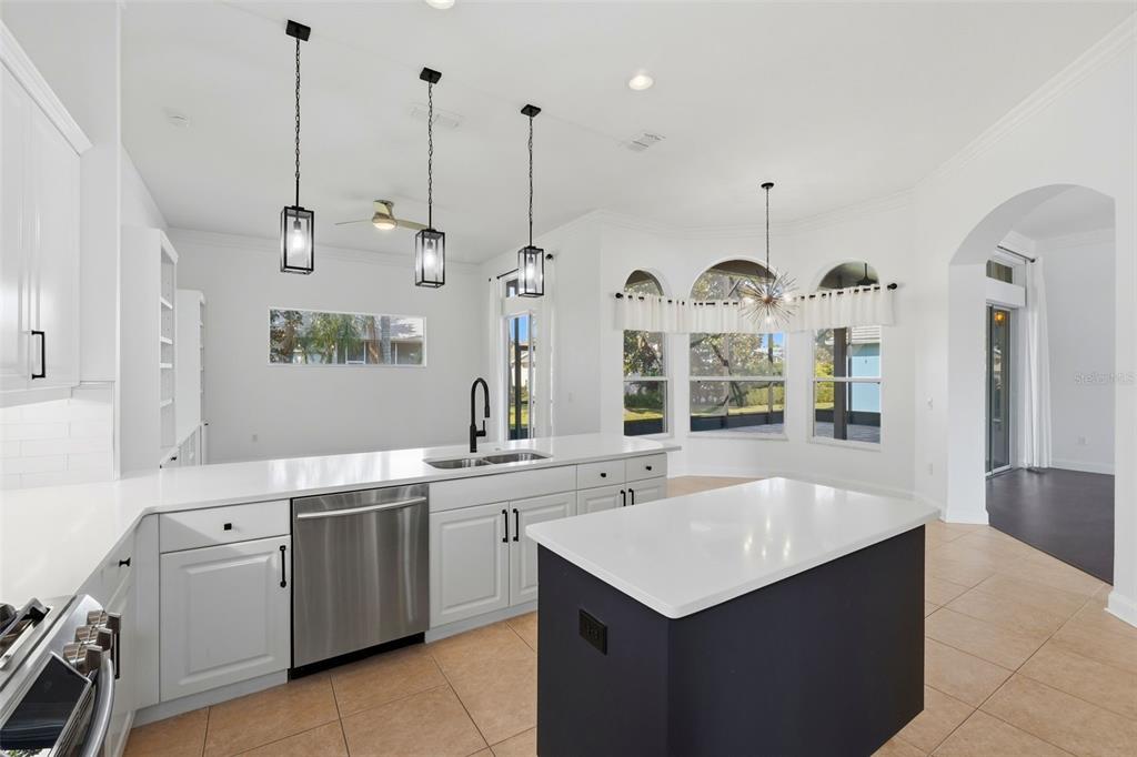 2822 Falcon Ridge Clermont, FL 34711 - Photo 13 of 59 a kitchen with a sink a stove and a clock
