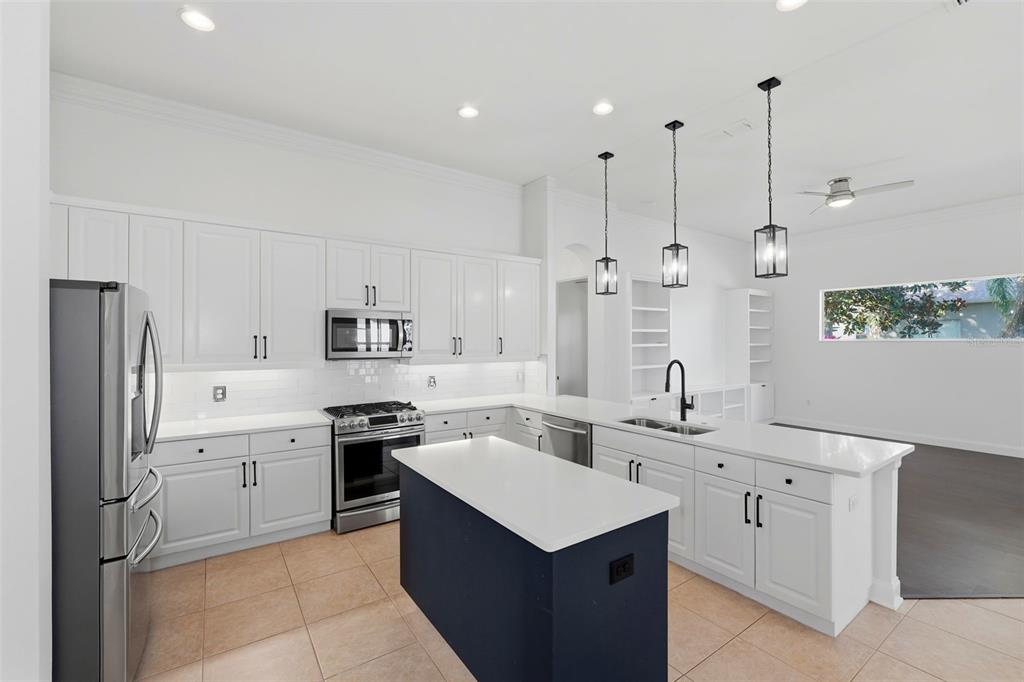 2822 Falcon Ridge Clermont, FL 34711 - Photo 14 of 59 a kitchen with white cabinets sink and refrigerator