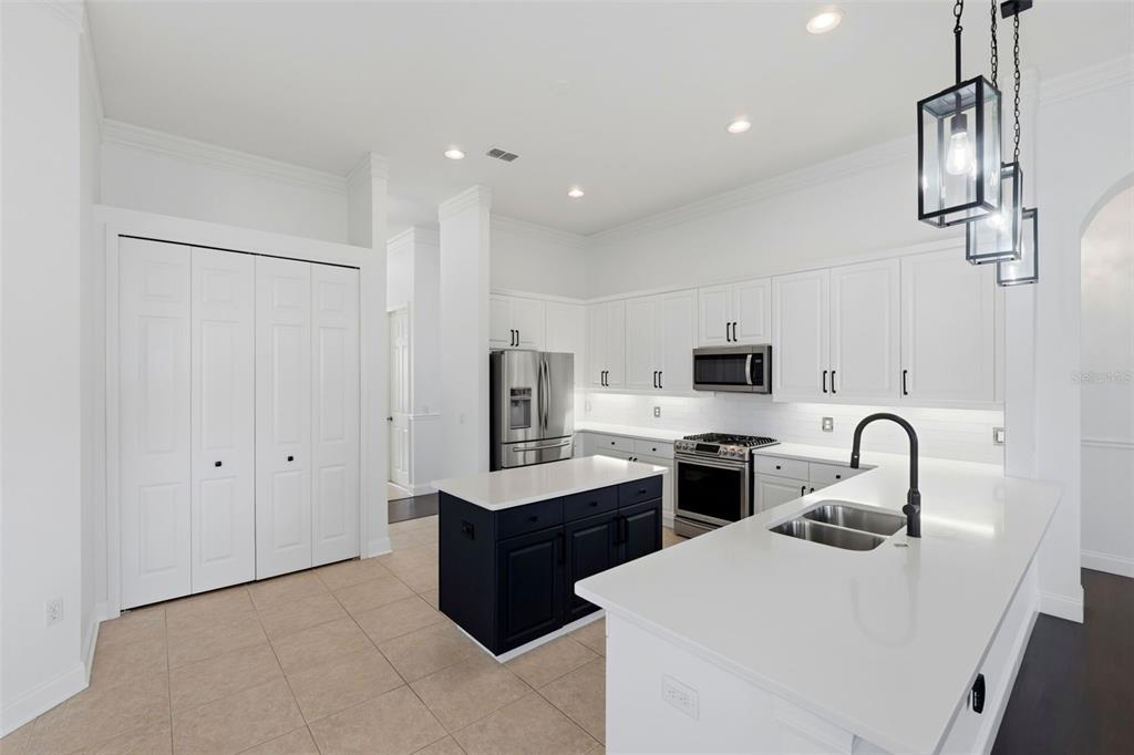 2822 Falcon Ridge Clermont, FL 34711 - Photo 16 of 59 a kitchen with stainless steel appliances a sink stove and refrigerator