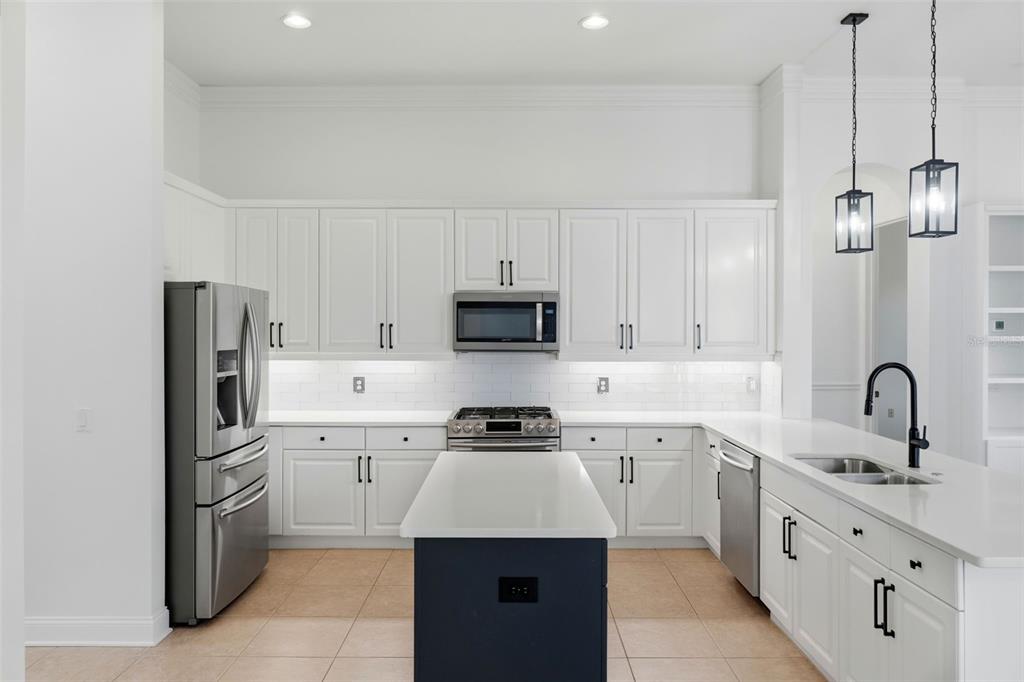 2822 Falcon Ridge Clermont, FL 34711 - Photo 17 of 59 a kitchen with a sink and white cabinets