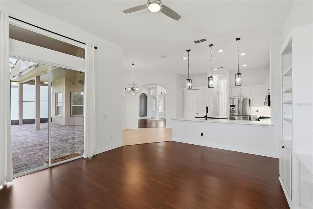 2822 Falcon Ridge Clermont, FL 34711 - Photo 20 of 59 a view of a kitchen with kitchen island a sink wooden floor and a large window