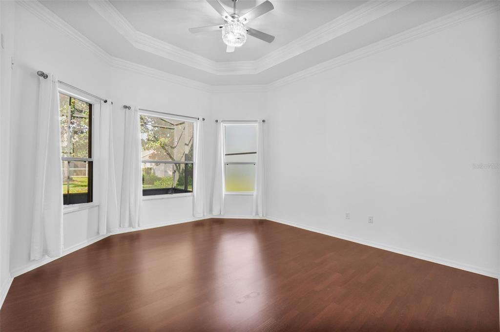 2822 Falcon Ridge Clermont, FL 34711 - Photo 25 of 59 an empty room with wooden floor and windows