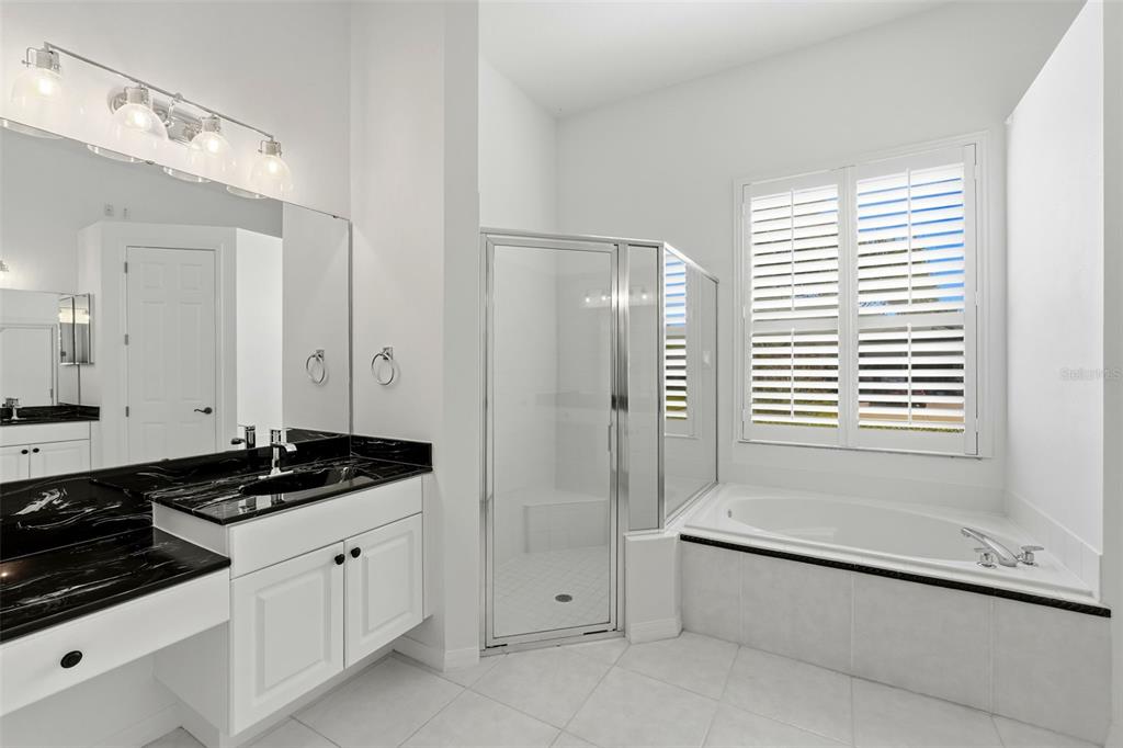 2822 Falcon Ridge Clermont, FL 34711 - Photo 28 of 59 a bathroom with a granite countertop sink a toilet and shower