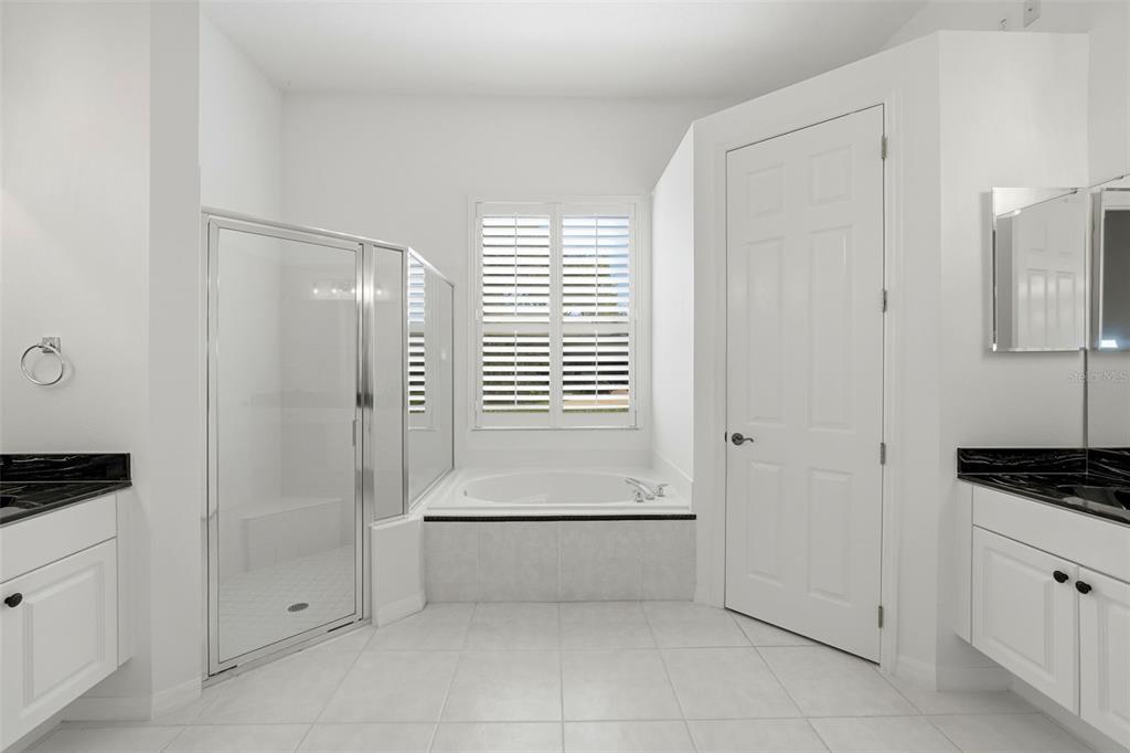 2822 Falcon Ridge Clermont, FL 34711 - Photo 29 of 59 a bathroom with a bathtub and a shower