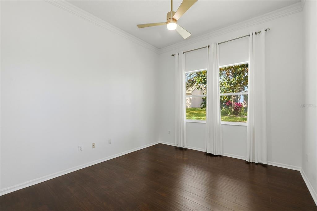 2822 Falcon Ridge Clermont, FL 34711 - Photo 32 of 59 an empty room with wooden floor and windows
