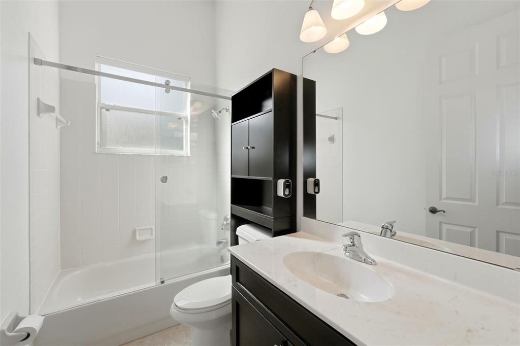 2822 Falcon Ridge Clermont, FL 34711 - Photo 35 of 59 a bathroom with a sink a toilet and shower