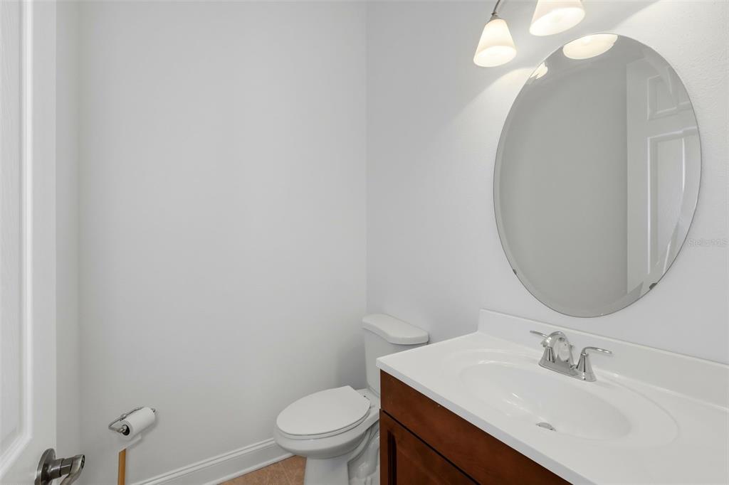 2822 Falcon Ridge Clermont, FL 34711 - Photo 36 of 59 a bathroom with a sink vanity mirror and toilet